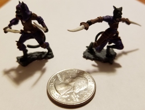 photo of tabaxi DnD miniatures with quarter to show size